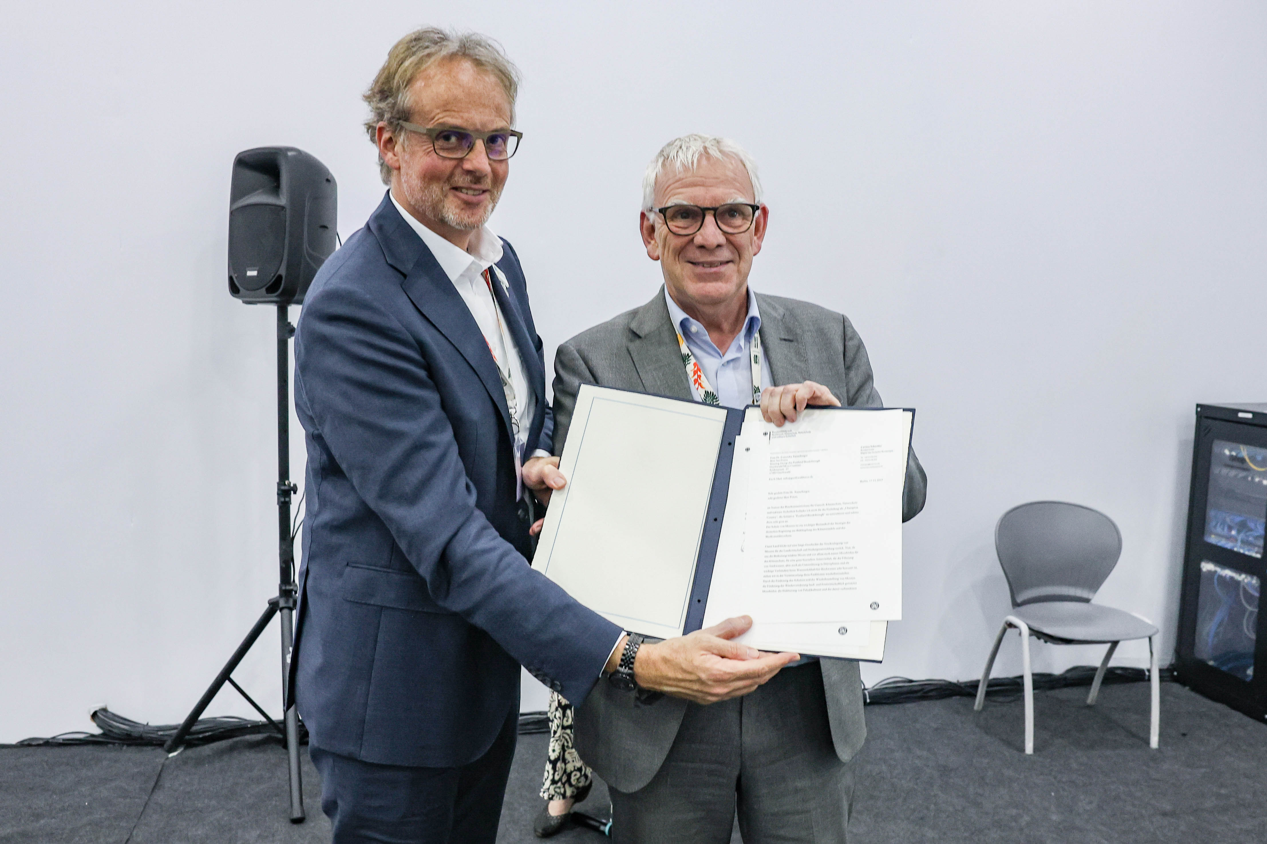 Coenraad Krijger (CEO of Wetlands International) and Jochen Flasbarth (State Secretary at the Federal Ministry for the Environment, Nature Conservation and Nuclear Safety, Germany) with the letter announcing Germany will be the newest Champion Country of the Peatland Breakthrough. Â© Peatland Breakthrough