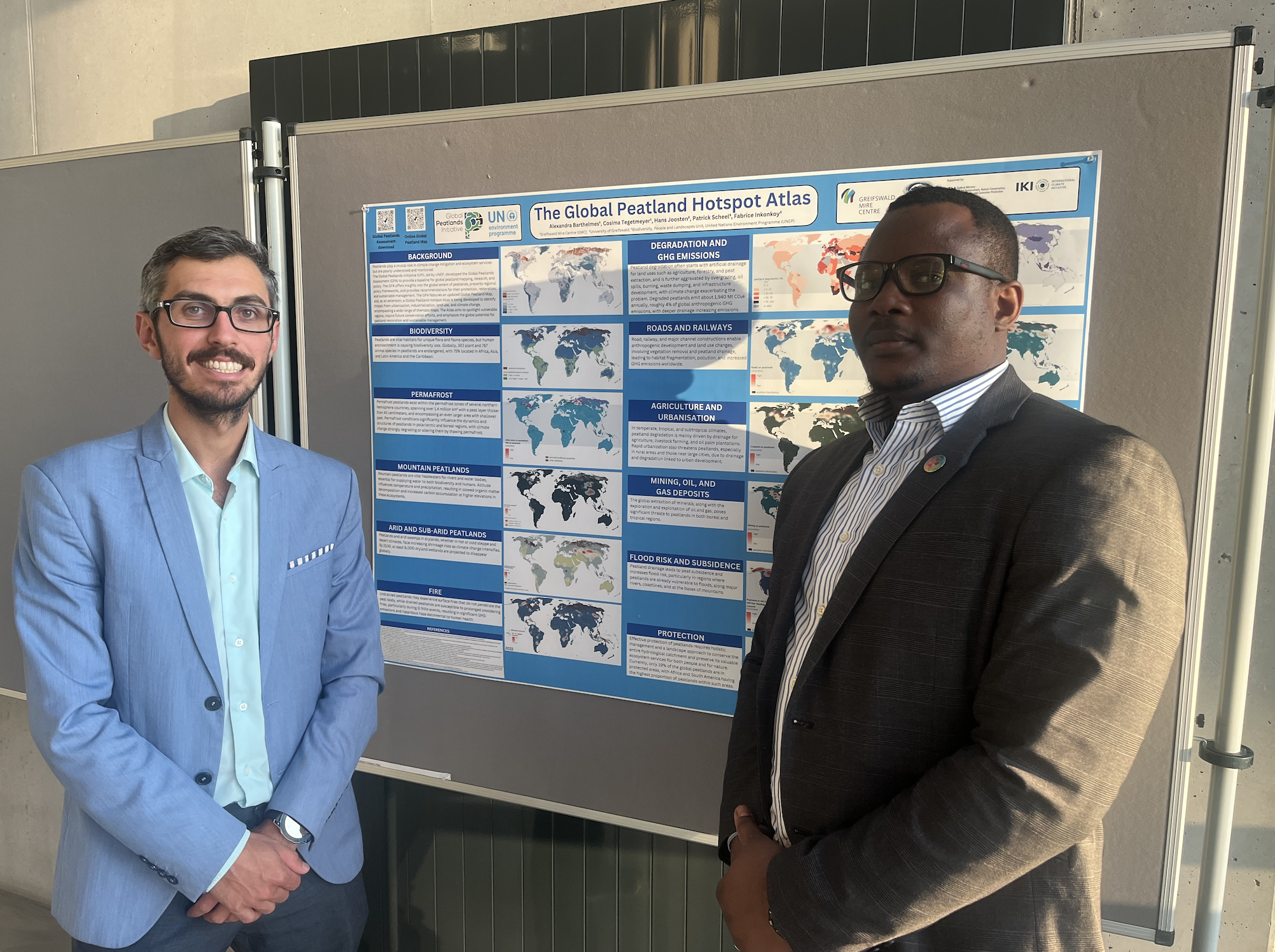 Patrick Scheel (left) and Fabrice Inkonkoy (right) with the Global Peatland Hotspot Atlas poster  